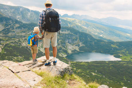 Father and son traveling in Rila mountains Bulgariaの写真素材
