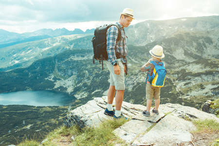 Father and son traveling in Rila mountains Bulgariaの写真素材