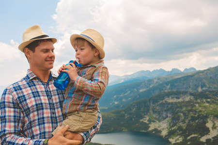 Father and son traveling in Rila mountains Bulgariaの写真素材