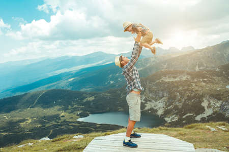 Father and son traveling in Rila mountains Bulgariaの写真素材