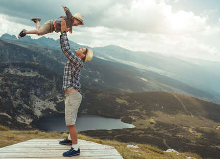 Father and son traveling in Rila mountains Bulgariaの写真素材