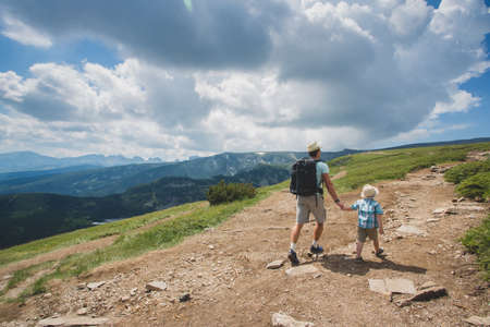 Father and son traveling in Rila mountains Bulgariaの写真素材