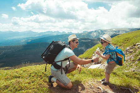 Father and son traveling in Rila mountains Bulgariaの写真素材