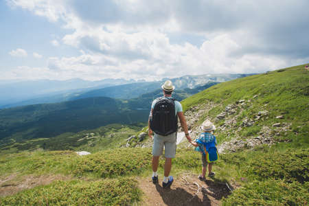 Father and son traveling in Rila mountains Bulgariaの写真素材
