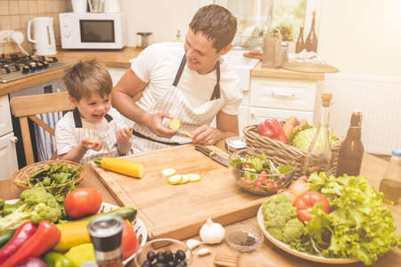 Father is cooking with his sonの写真素材