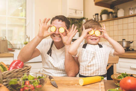 Father is cooking with his sonの写真素材