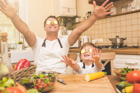 Father is cooking with his sonの写真素材