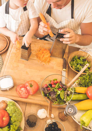 Father is cooking with his sonの写真素材
