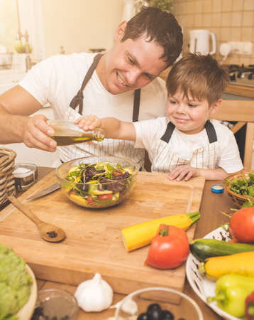 Father is cooking with his sonの写真素材