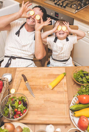 Father is cooking with his sonの写真素材
