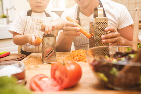 Father is cooking with his sonの写真素材