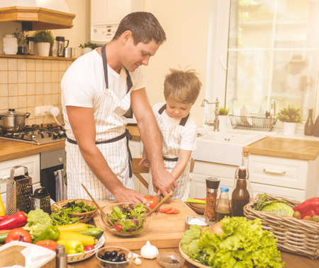 Father is cooking with his sonの写真素材