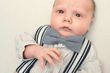 newborn baby dressed like gentlemanの写真素材
