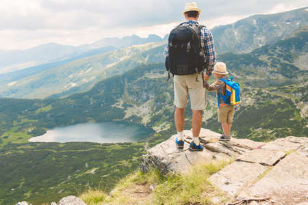 Father and son traveling in Rila mountains Bulgariaの写真素材