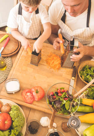 Father is cooking with his sonの写真素材