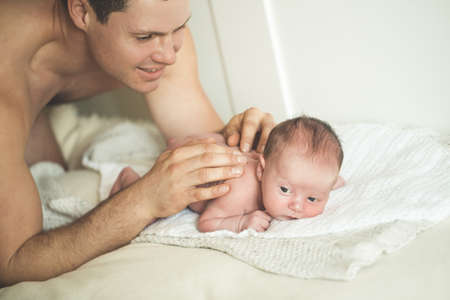 Dad is doing massage to a young sonの写真素材
