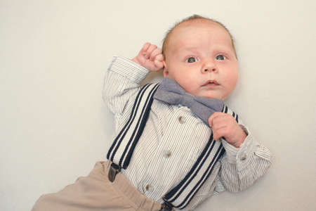 newborn baby dressed like gentlemanの写真素材