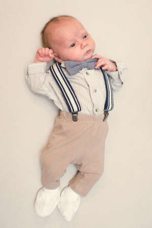 newborn baby dressed like gentlemanの写真素材