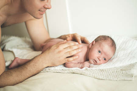 Dad is doing massage to a young son