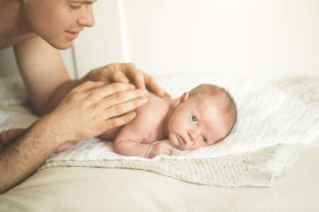 Dad is doing massage to a young sonの写真素材