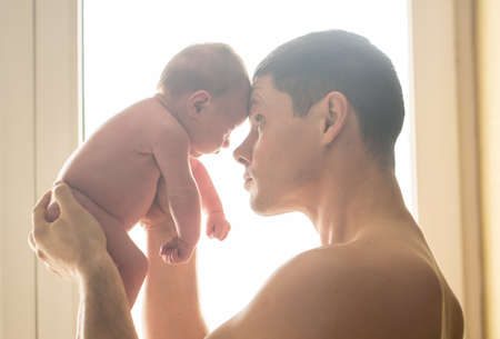 Beautiful dad with his son in his arms