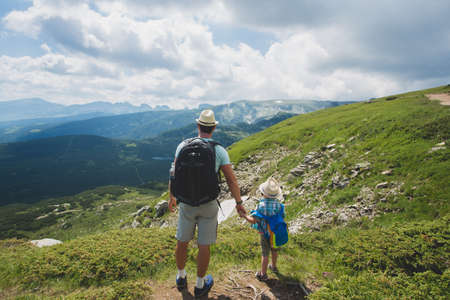 Father and son traveling in Rila mountains Bulgariaの写真素材