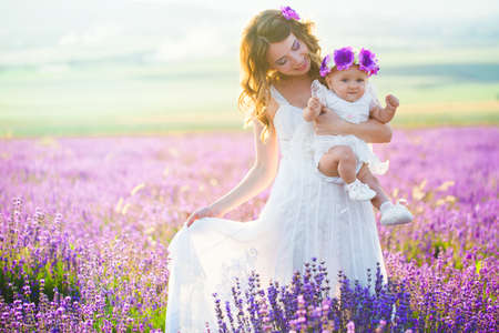 Mom and her daughter in a lavender fieldの写真素材