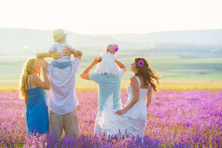 Two friendly family in a lavender fieldの写真素材