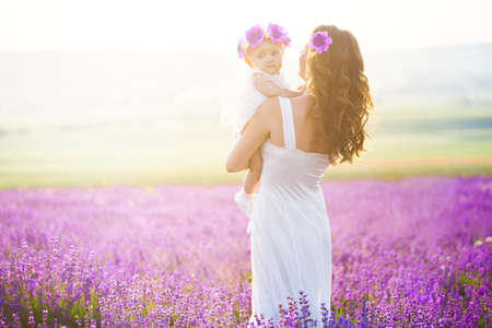 Mom and her daughter in a lavender fieldの写真素材