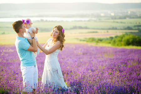 Young family in a lavender fieldの写真素材