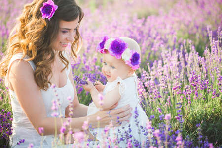 Mom and her daughter in a lavender fieldの写真素材