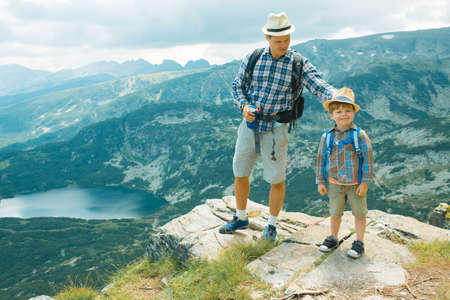 Father and son traveling in Rila mountains Bulgariaの写真素材