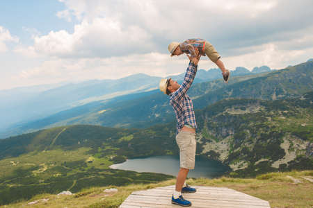Father and son traveling in Rila mountains Bulgariaの写真素材