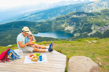 Family on a picnic in the mountainsの写真素材