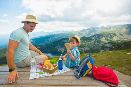 Family on a picnic in the mountainsの写真素材