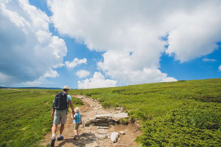 Father and son traveling in Rila mountains Bulgariaの写真素材