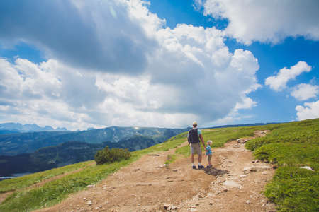 Father and son traveling in Rila mountains Bulgariaの写真素材
