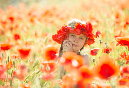 Little girl in a poppiesの写真素材