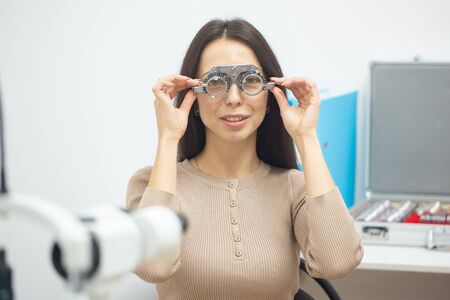 Diagnostic cabinet A young girl is diagnosed with vision and contact lenses are selected.の写真素材