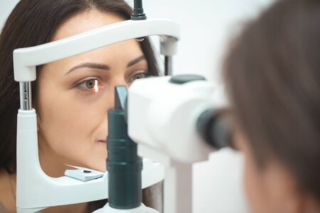 Diagnostic cabinet A young girl is diagnosed with vision and contact lenses are selected.の写真素材