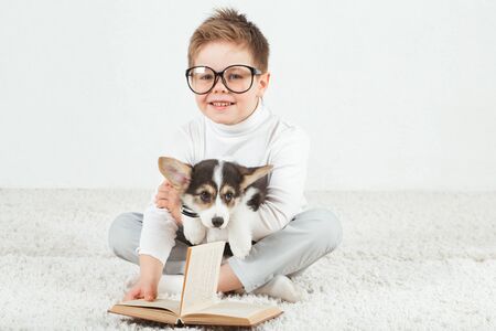 Teen boy and Corgi puppy with glassesの写真素材