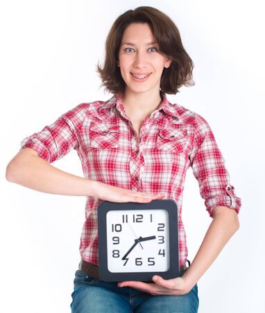 Girl in a plaid shirt with multi-colored braces holding a watchの写真素材