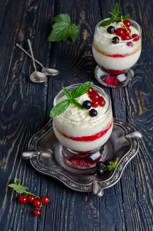 Sweet dessert with berry and cottage cheese in a glassの写真素材