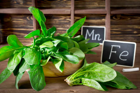 Spinach rich in vitamin C, manganese and iron on a dark backgroundの写真素材