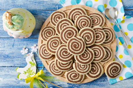 Cookies in the form of a spiral on a wooden tray. Handmade biscuits for Easterの写真素材