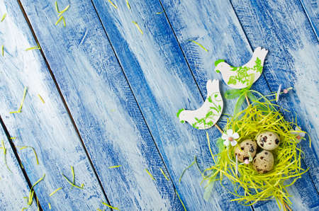 Easter decoration on blue background. Birds in the nestの写真素材