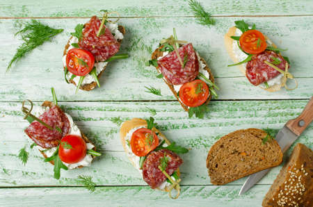 Fresh toast sandwiches with cottage cheese, salami, cherry tomatoes and arugulaの写真素材