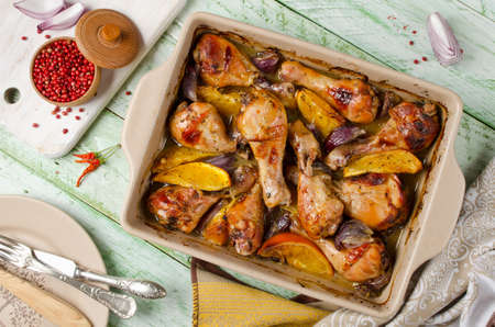 Oven-roasted orange chicken with red onion. Roasted honey chicken legsの写真素材