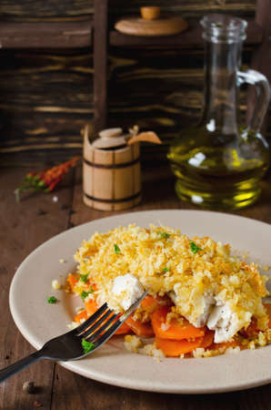 Oven-roasted fish fillet with carrots under a bread crust. For garnish white riceの写真素材