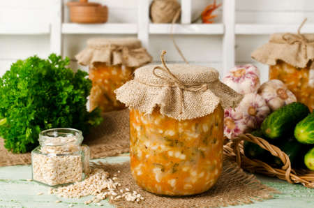 Soup in a jar. Russian cuisine: soup with pickled cucumbers and pearl barleyの写真素材